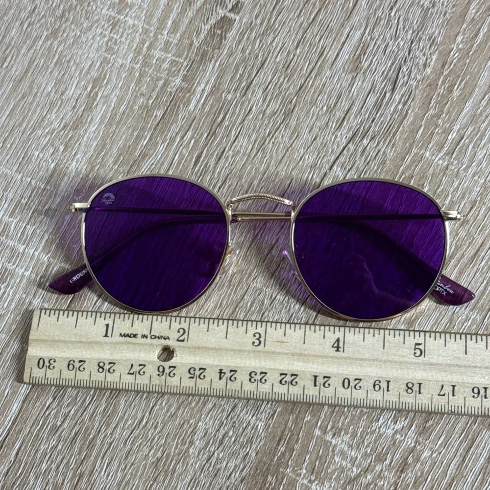 Rainbow OPTX Round sunglasses a gold metal frame and indigo purple lenses